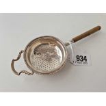 A tea strainer with turned wood handle, Birmingham 1931