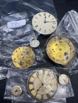 A bag of four pocket watch movements three wrist watch movements including one OMEGA