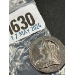 Small silver 1897 medallion