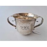 Porringer with two scroll handles . 5.5 in over handles . London 1901. 170gms