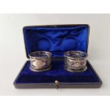 A pair of pierced boxed napkin rings, Sheffield 1910 by R J M