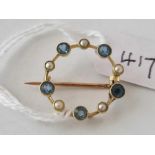A antique circular aquamarine and pearl set brooch 15ct gold