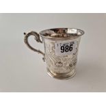 A Victorian Christening mug engraved and chased with flower mottifs,3" high, London 1853 by EB & JB,