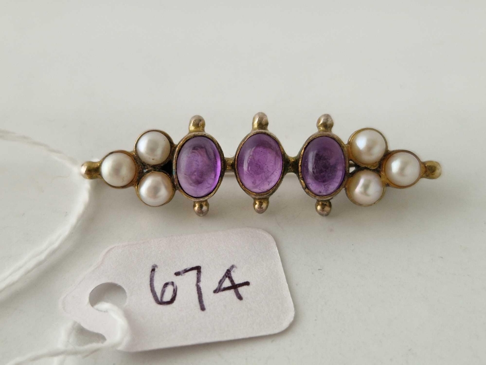 A vintage silver pearl and cabochon amethyst set brooch