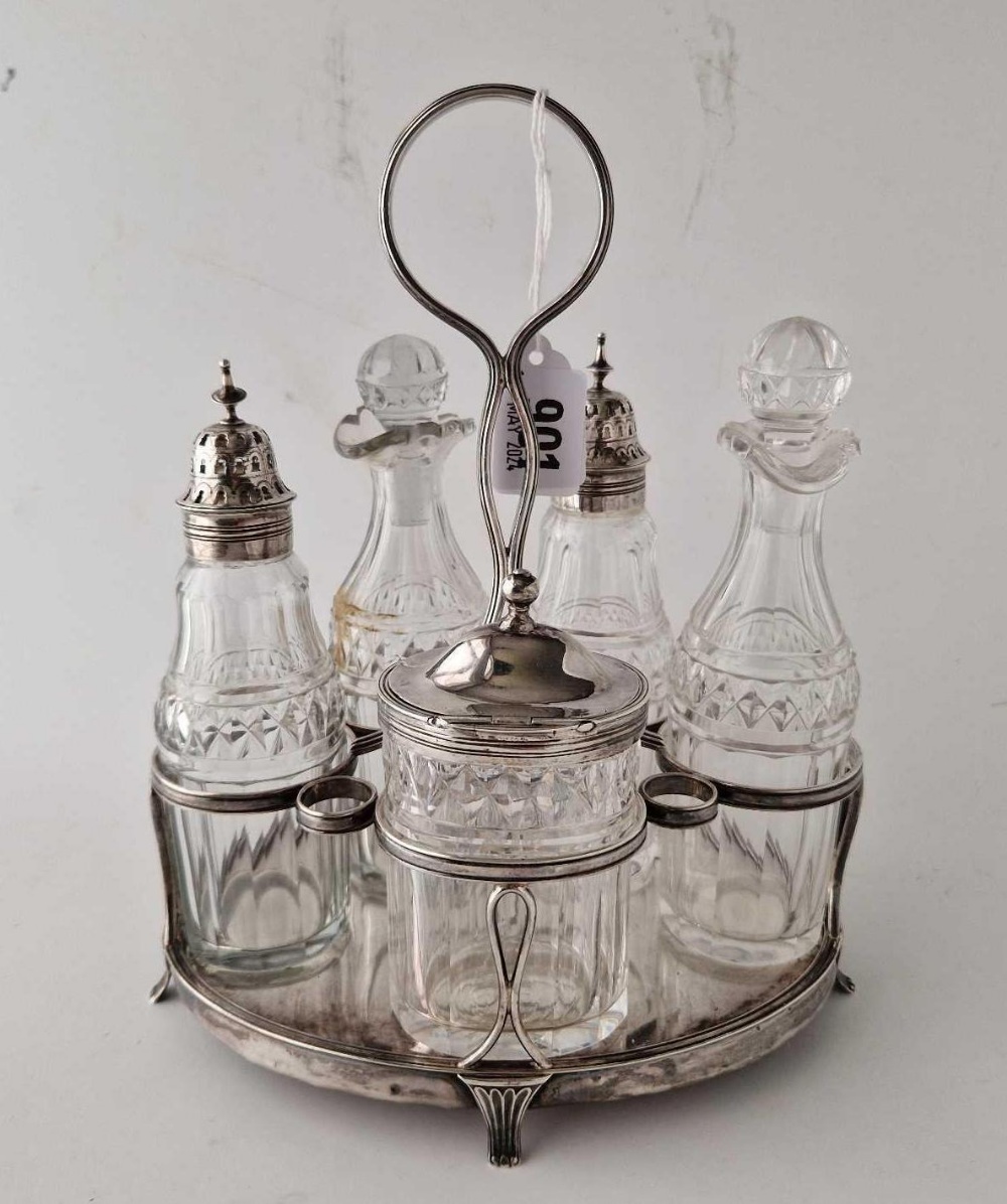 A good oval George III cruet set with five bottles and central ring handle, 9.5 inches high,