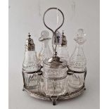 A good oval George III cruet set with five bottles and central ring handle, 9.5 inches high,