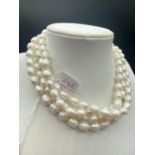 A fancy long chain white pearl necklace 50 inch 94 gms