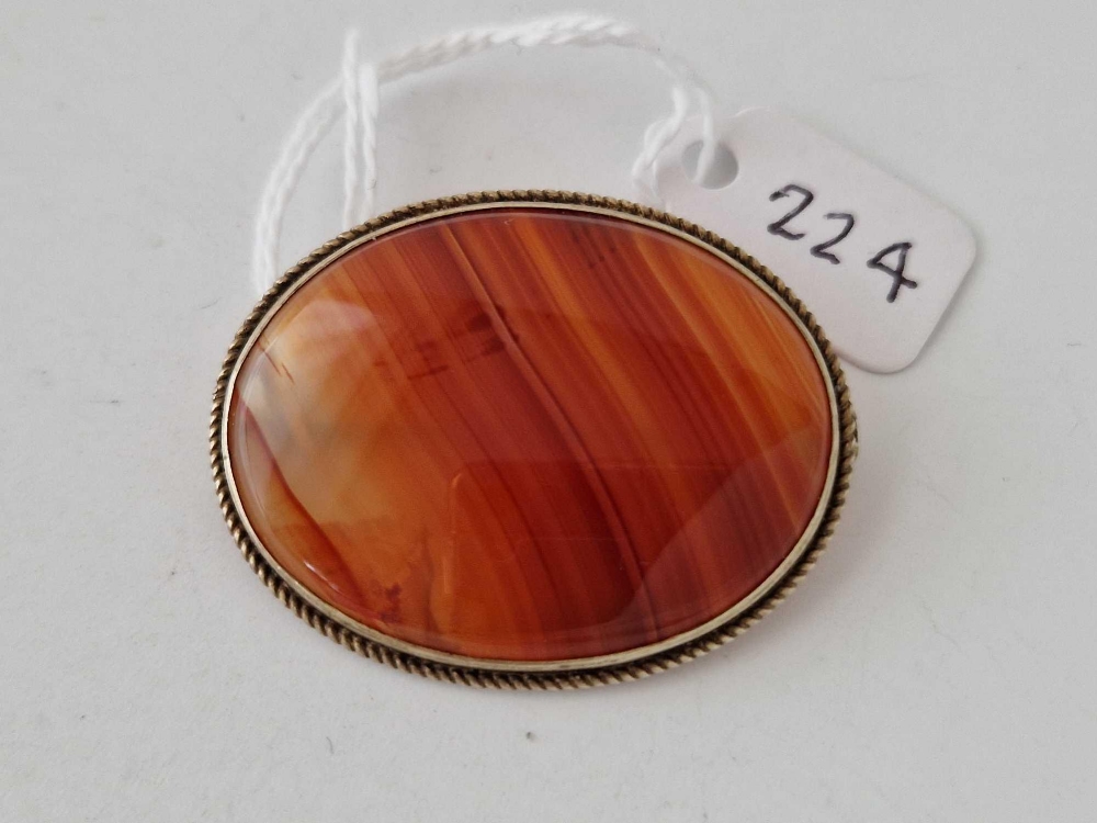 A oval silver mounted agate set brooch