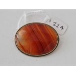 A oval silver mounted agate set brooch