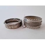 Two white metal bracelets