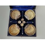 Boxed set of Four shell shaped salts with matching spoons. Chester 1895