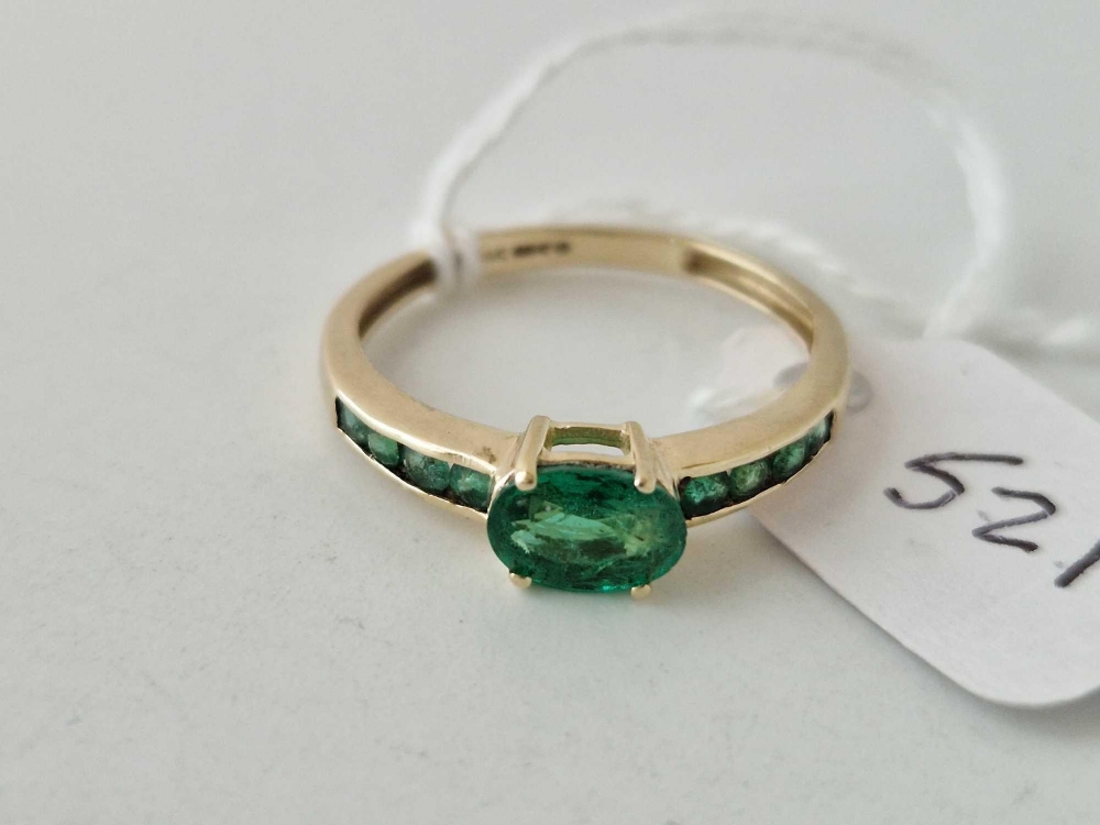 A Emerald single stone ring with emerald set shoulders 9ct size P 2 gms