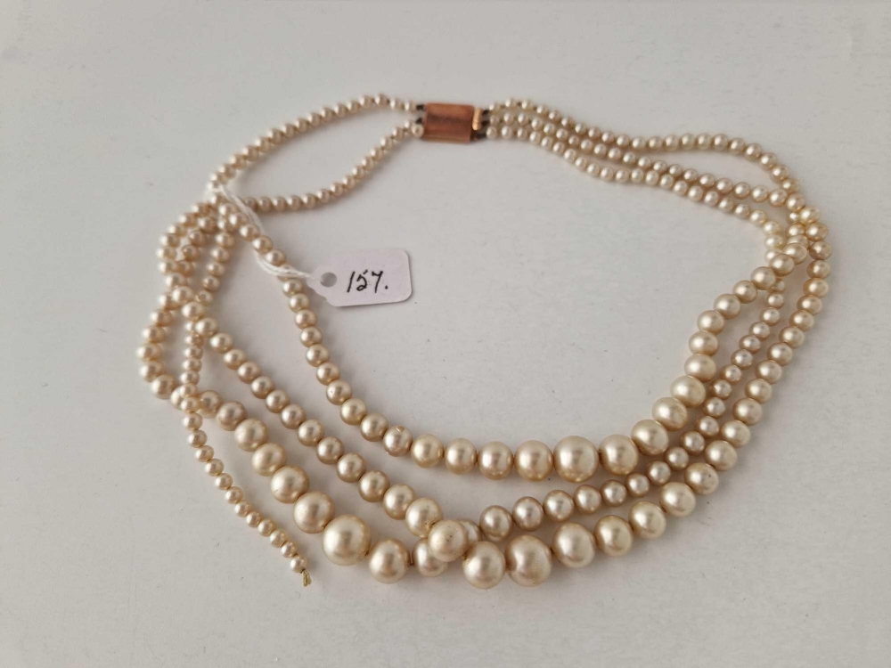 A three string pearl necklace with 9ct clasp AF