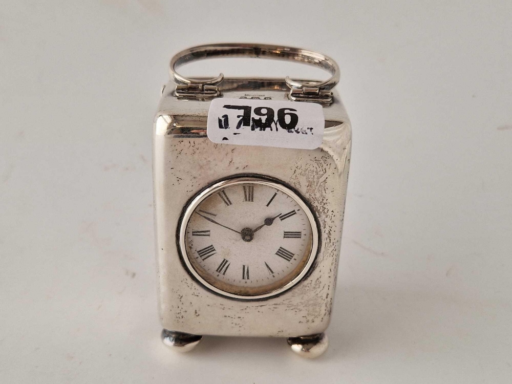 Carriage clock with Roman enamel dial and swing handle. 4.5 in over handle.Birmingham 1921 By H W