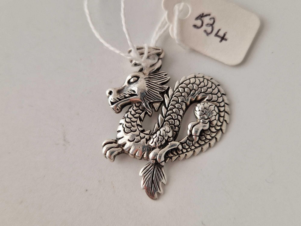 A silver dragon pendant