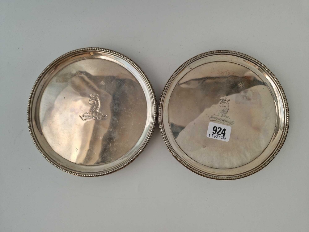 A good pair of George III salvers with crested centres, beaded rims and three bracket feet, 7 inches