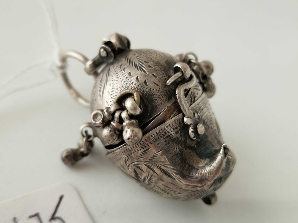 A unusual hinged tribal silver pendant opening to reveal two compartments