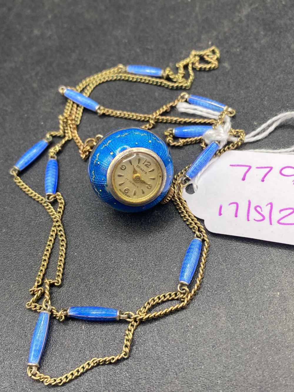A silver and enamel ball watch by ORNATA with neck chain