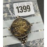an interesting Roman coin in a silver and diamond mounted brooch