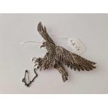 A silver and marcasite brooch in the form of a flying eagle 88mm across