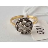 A diamond cluster ring 18ct gold size M 3.5 gms