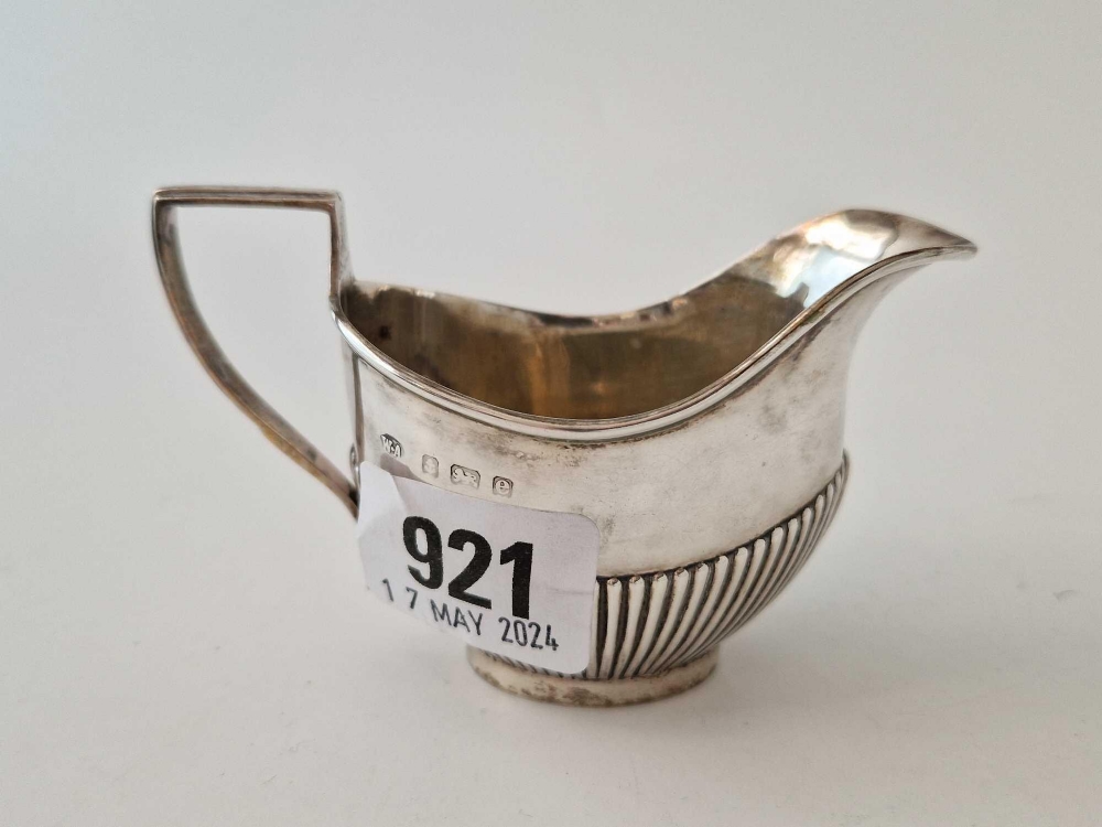 An oval half fluted small cream jug, Birmingham 1904 by WA, 42 g.