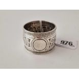 A Victorian napkin ring with chased decoration, London 1887