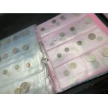 Foreign coins mounted in an album