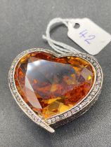 A OVERSIZED SILVER FRENCH HEART SHAPED ORANGE CITRINE GEM STONE AND WHITE SAPPHIRE PENDANT