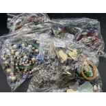 Four large bags of assorted costume jewellery