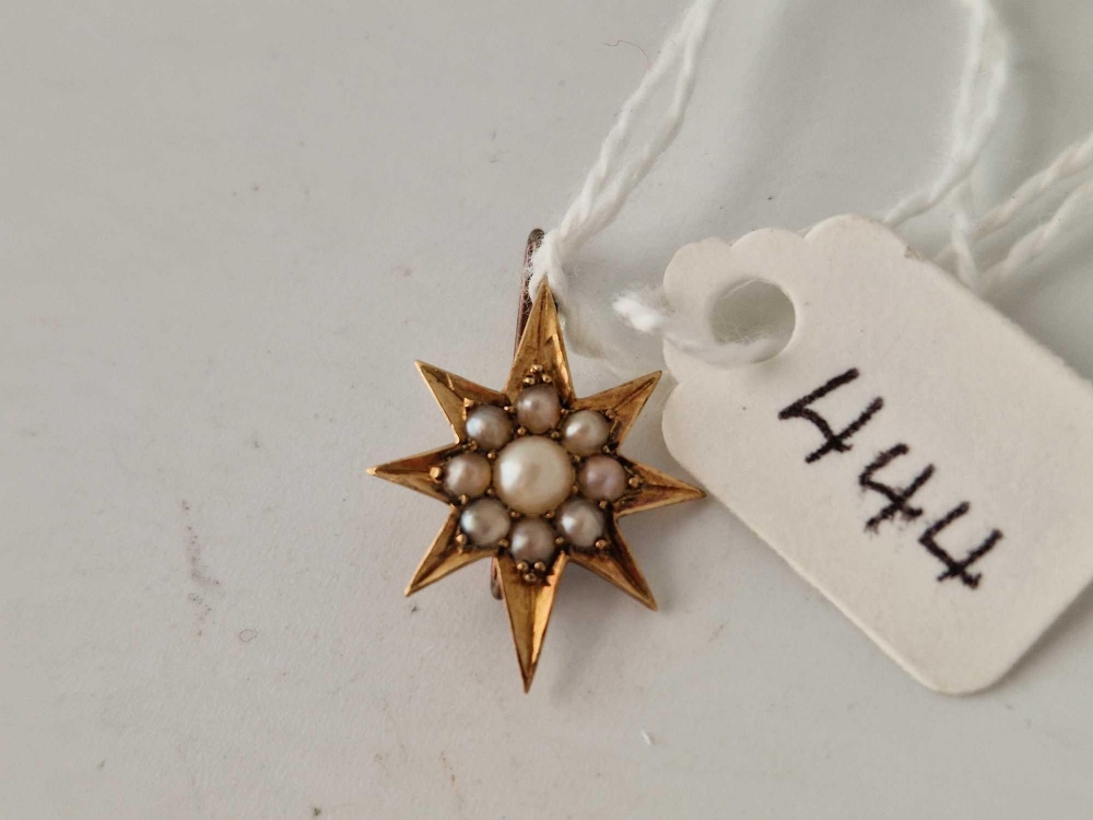 A small pearl star brooch set in 15ct gold