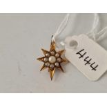 A small pearl star brooch set in 15ct gold