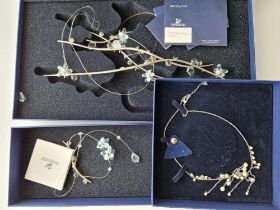 Three boxes of SWAROVSKI items two window decorations and one necklace in original boxes