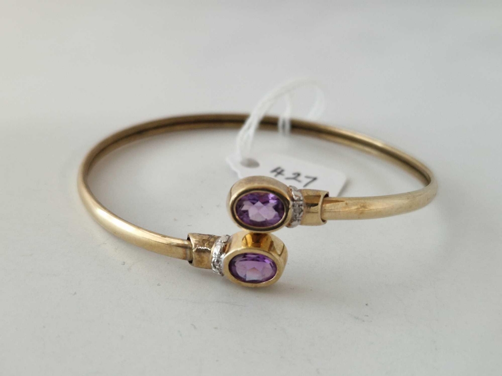 A amethyst and diamond bangle 9ct 6.8 gms