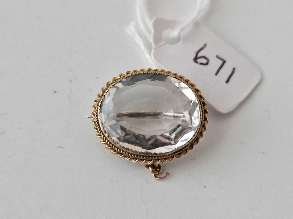A antique oval brooch set with rock crystal