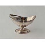 A George III boat shaped sugar basket with reeded rims, swing handle, 5.5 inches wide, London 1794