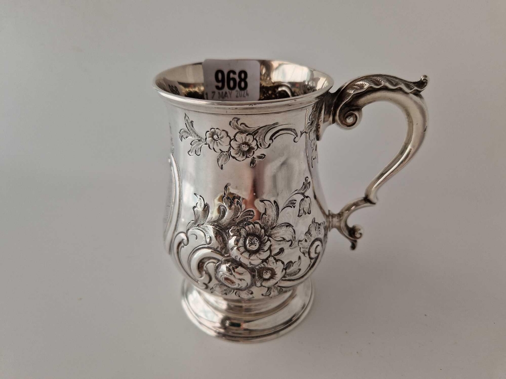 A good quality Victorian embossed tankard decorated with flowers, 5" high, London 1866 by RH, 317g