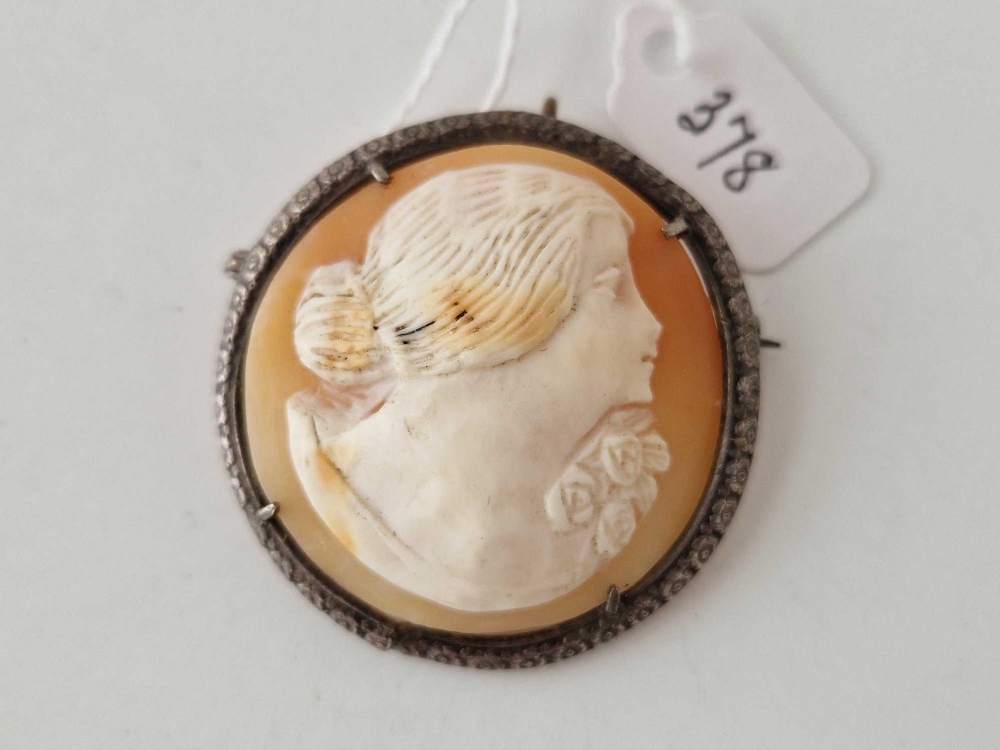 A circular cameo brooch