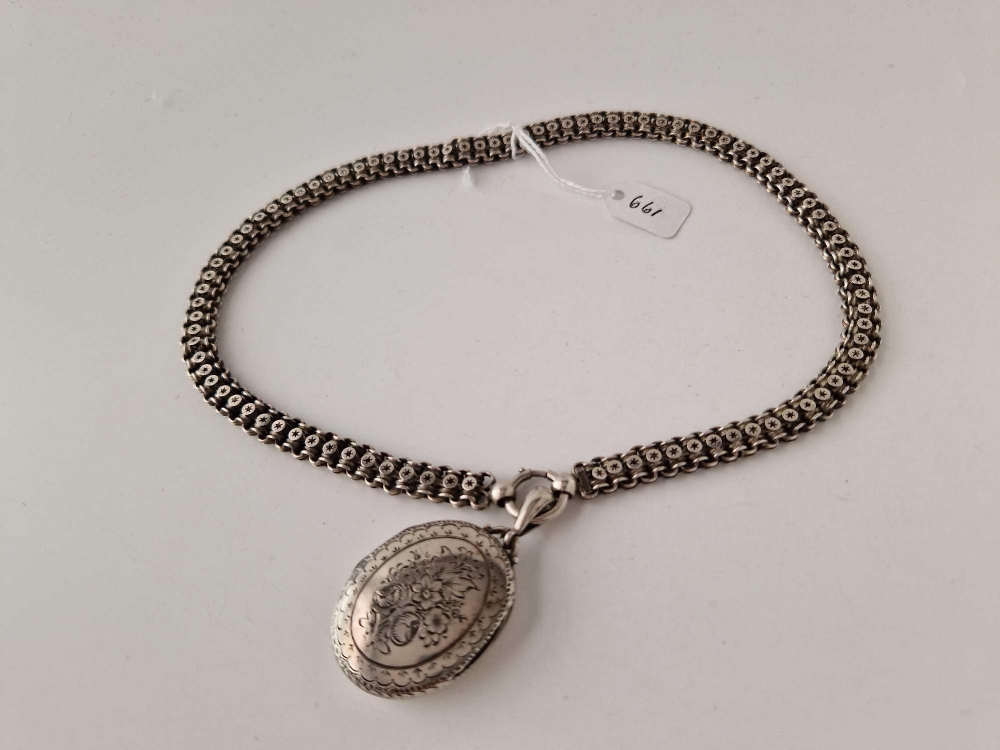 A Victorian engraved silver locket and chain Birmingham 1895 40 gms
