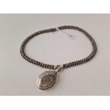 A Victorian engraved silver locket and chain Birmingham 1895 40 gms