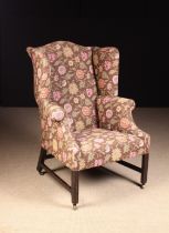 A George III Upholstered Wing Armchair.