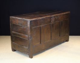 A Large Mid 17th Century Oak Coffer. The three plank lid with moulded front edge and reduced sides.
