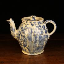 A Wetherigg's Pottery Teapot with stippled blue glaze on a cream glazed ground and sgrafitto