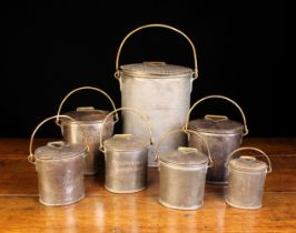 A Group of Seven Dairy/Cream Canisters of oval form with brass hinged lids and brass swing handles.