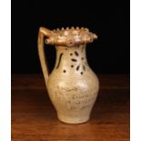 A Burton in Londsdale Stoneware Puzzle Jug with a serrated rim featuring five protuberant spouts