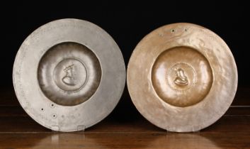 A Pair of Unusual 16th Century hammered Copper Alloy Dishes with repoussé centre bosses of King's