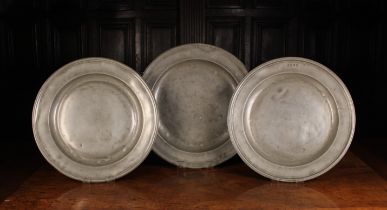 Three Antique Pewter Chargers: One with moulded rim and four touch marks to the border,