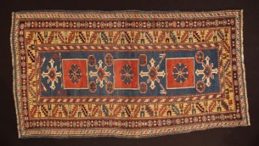 An Antique Caucasian Wool Rug 65" x 35½" (165 cm x 90 cm).