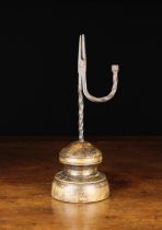 An Early 19th Century Wrought Iron Rushnip with a faceted finial to the upswept wrythen arm,