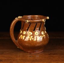 A Halifax Puzzle Jug dated 1877 and initialed MH with decorative yellowy-cream slip daubs and a